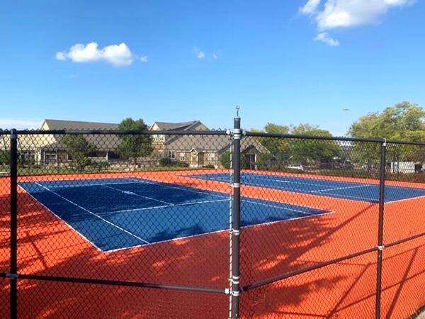 HOA orange and blue pickleball courts
